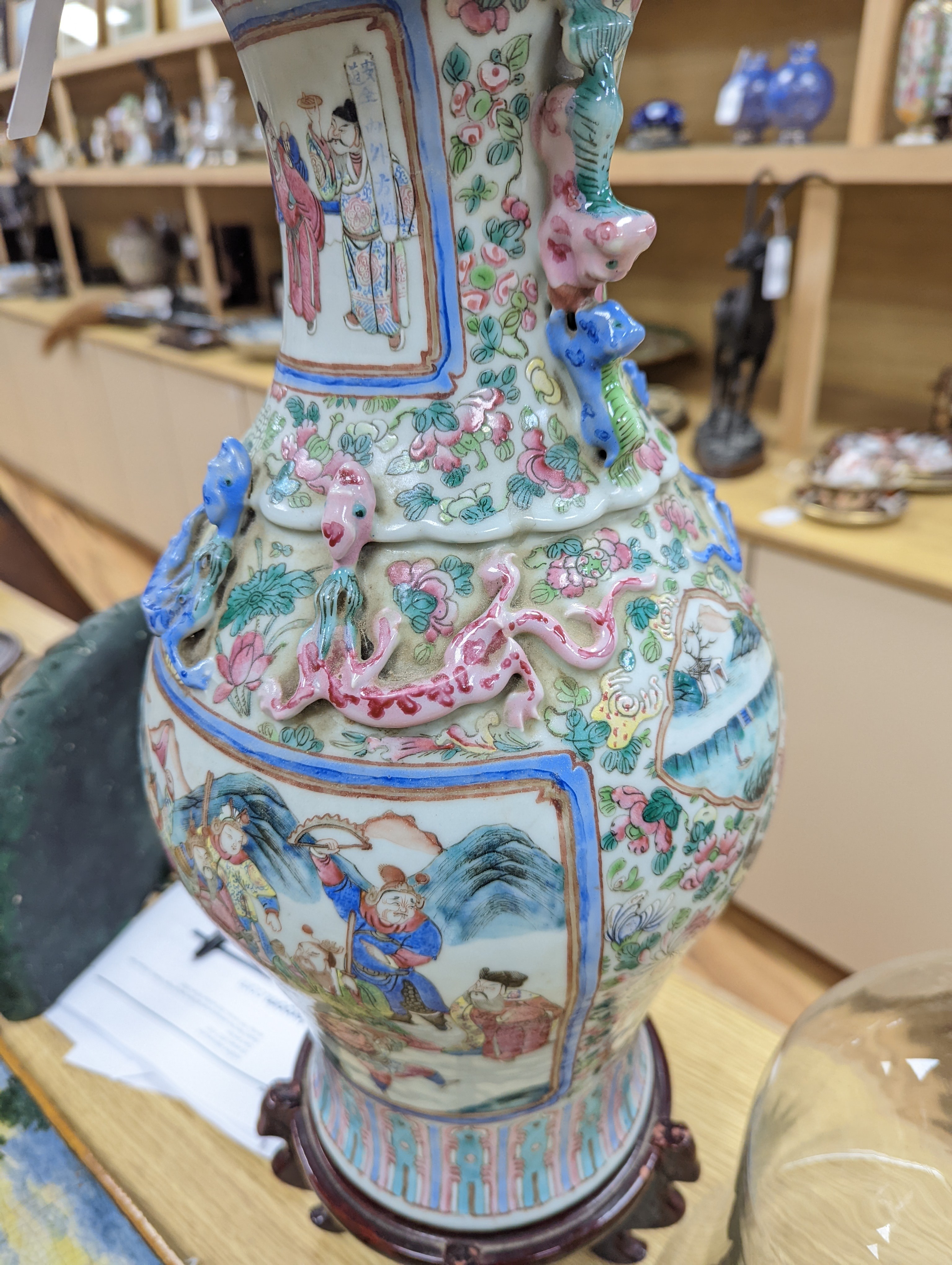 A large Chinese famille rose two handled vase, late 19th century, wood stand, restored 54cm incl stand